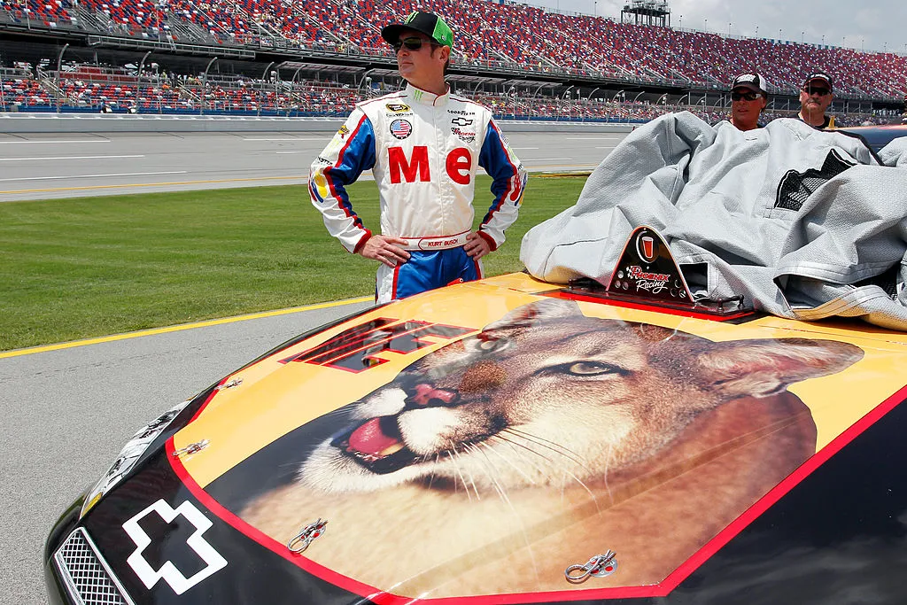 Kurt Busch, driver of the #51 Phoenix Construction Services Chevrolet, stands on the grid during qualifying for the NASCAR Sprint Cup Series Aaron's 499 at Talladega Superspeedway on May 5, 2012 in Talladega, Alabama. Busch is running the &quot;ME&quot; paint scheme from the &quot;Talladega Nights&quot; film. No speeding tickets in NASCAR.