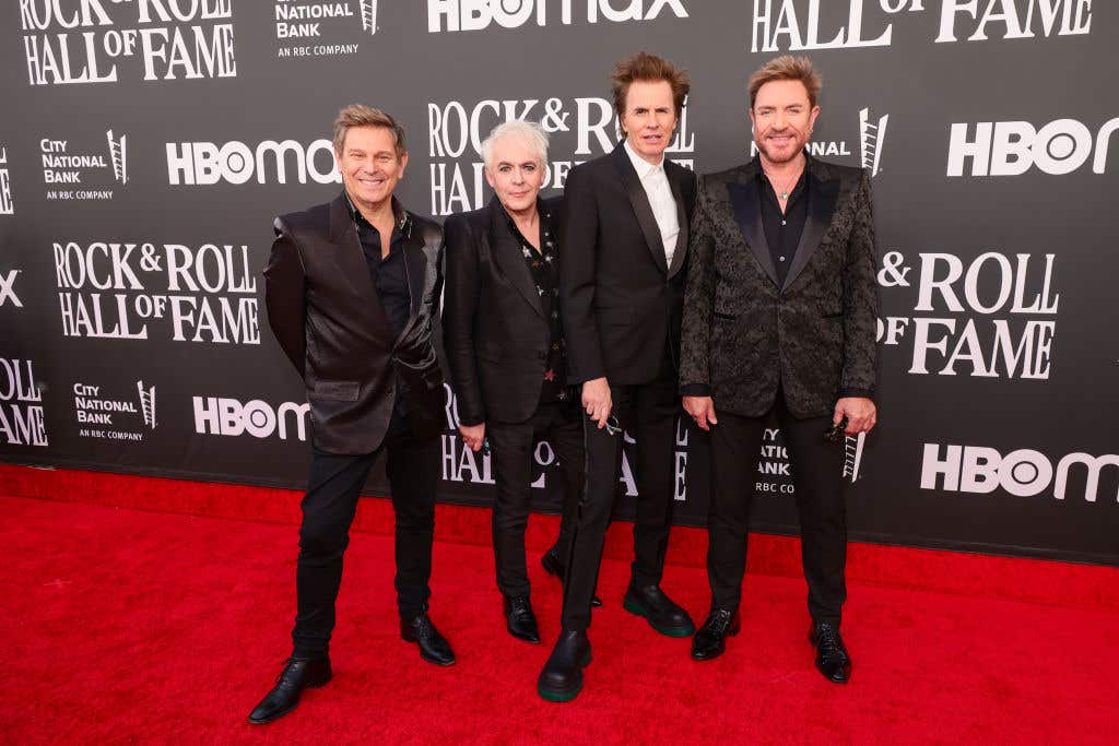 Duran Duran in black suits on the red carpet of the Rock and Roll Hall of Fame induction ceremony