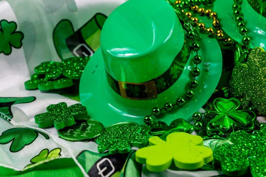 Green top hat surround by green beads and shamrocks for ways to celebrate St. Patty's Day Weekend in Fort Myers and Naples