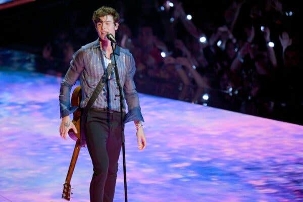 Shawn Mendes with his guitar performing on stage during the 2019 MTV Video Music Awards