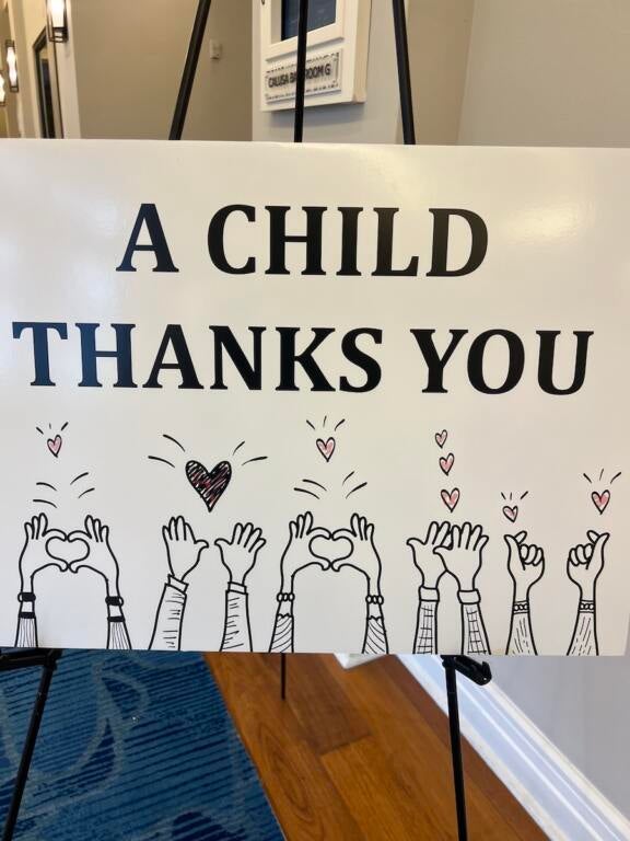 A sign readng "A Child Thanks You"