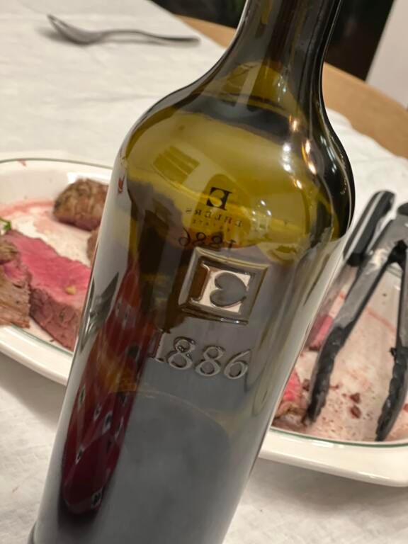 Bottle of Ehler's Estate 1886 Cabernet Sauvignon in front of a plate of sliced, rare tenderloin for Wining And Dining Events In SWFL