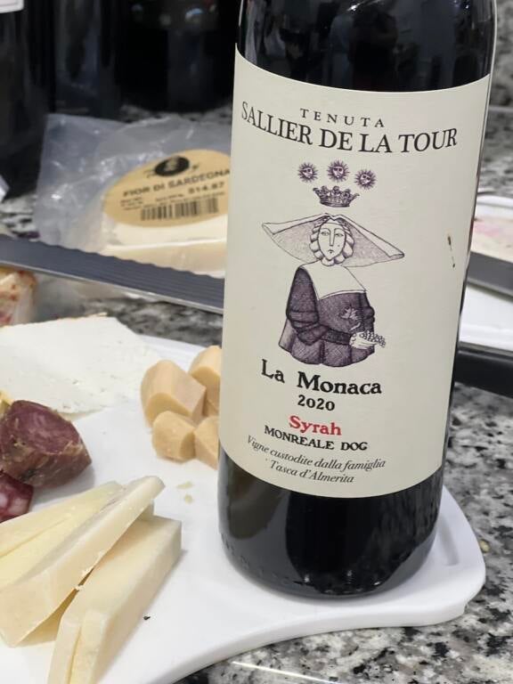 Bottle of Sallier de La Tour Syrah with cheese and dried meats in the background