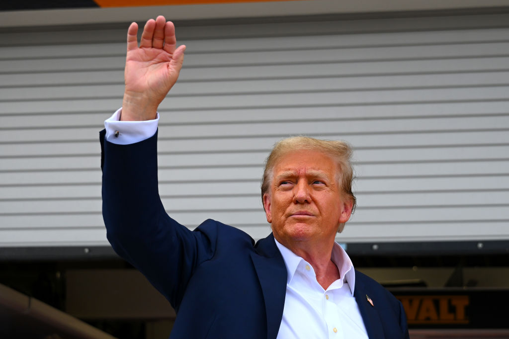 Donald Trump waves to the crowd in the Pitlane prior to the F1 Grand Prix of Miami at Miami International Autodrome on May 05, 2024 in Miami, Florida.  many Floridians would break up over politics. 