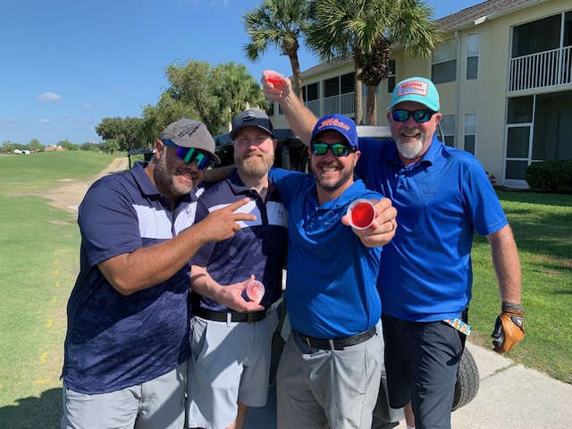 Golfers doing jello shots trying to be the drunkest golfers on the course