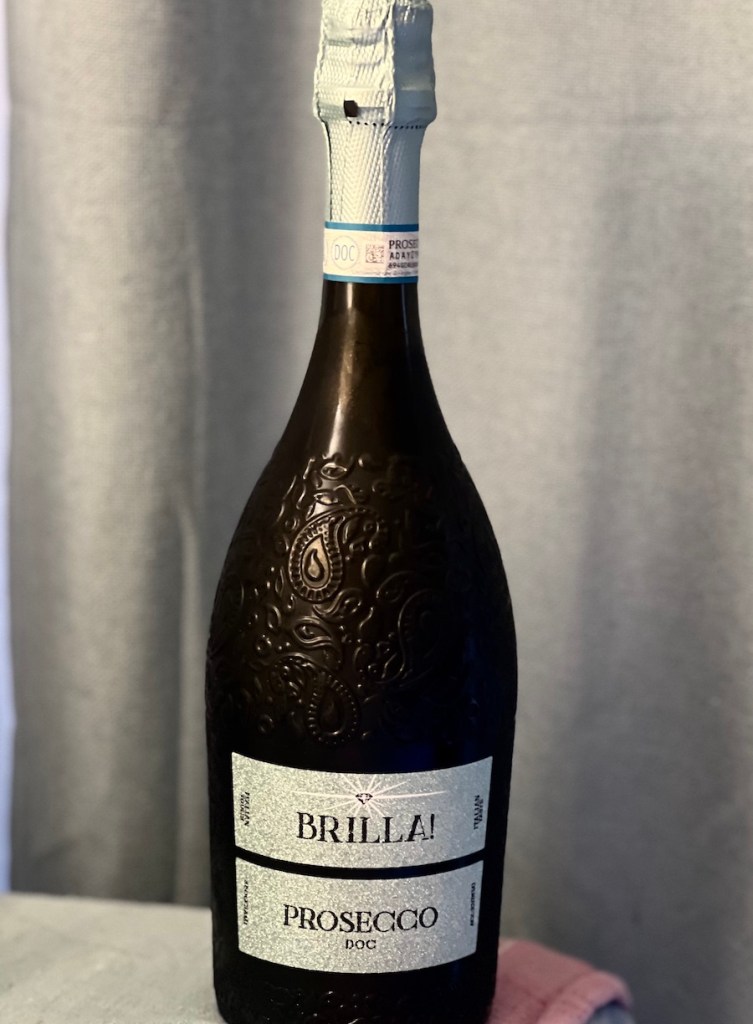 Bottle of BRILLA! Prosecco with a light blue label and background