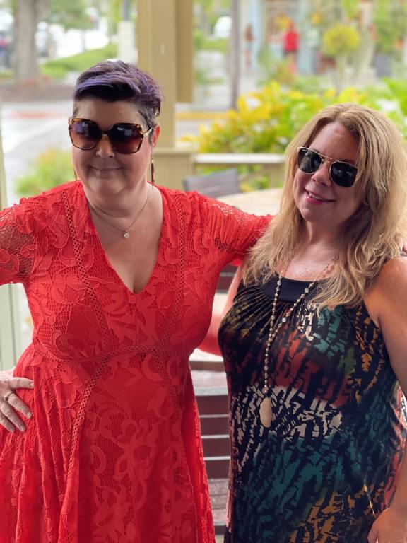 Two girls smiling, one dressed in red the other in black for Hispanic Heritage Month and wine