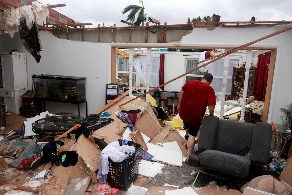 Robert Haight salvages what he can from his home after what appeared to be a tornado tore the roof off before Hurricane Milton's arrival on October 09, 2024, in Fort Myers, Florida. He said he had just had the roof replaced two years after Hurricane Ian had damaged it. People are preparing for the storm, which could be a Cat 3 when it makes landfall on Wednesday evening. 