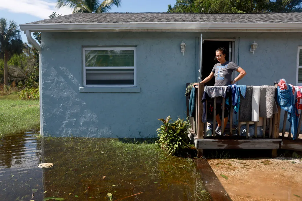 Ramona Vasquez works on drying items from her home after being inundated with water when Hurricane Milton passed through the area on October 10, 2024, in Punta Gorda, Florida. The storm made landfall as a Category 3 hurricane in the Siesta Key area of Florida, causing damage and flooding throughout Central Florida. 