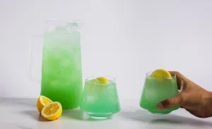 A tall pitcher filled with greenish blue beverage and two glasses filled with the same, topped with a lemon slice